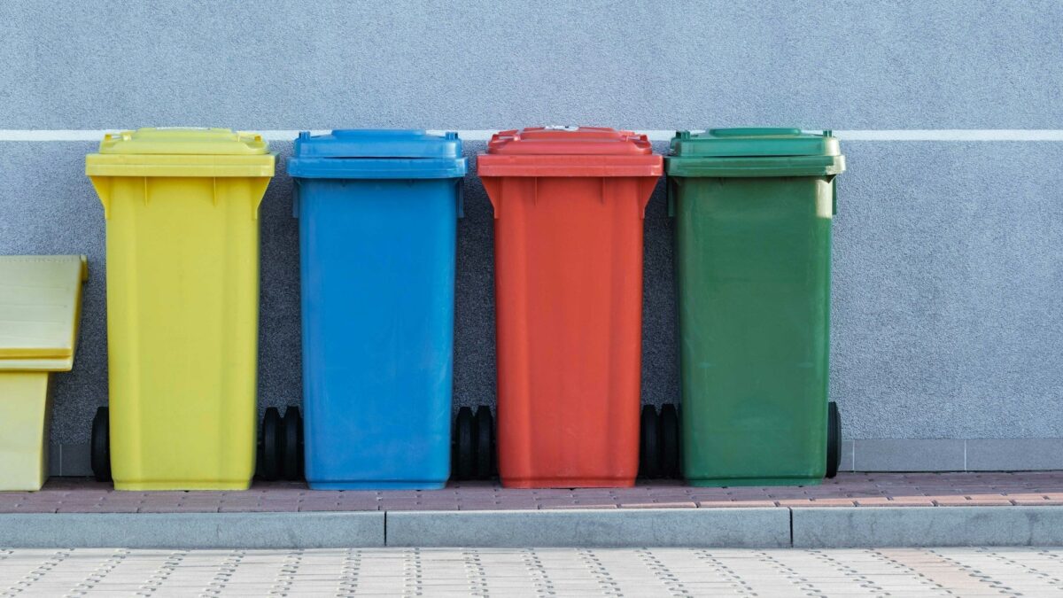 Four trash bins at a wall